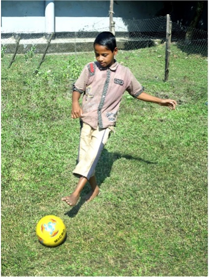 A boy playing football after treatment